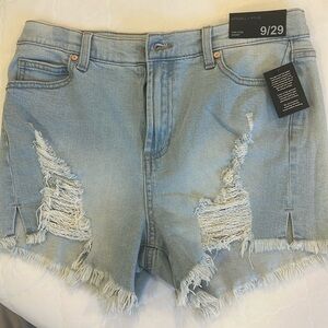 Distressed frayed faded cut off stretchy  denim shorts with five pockets. NWT.